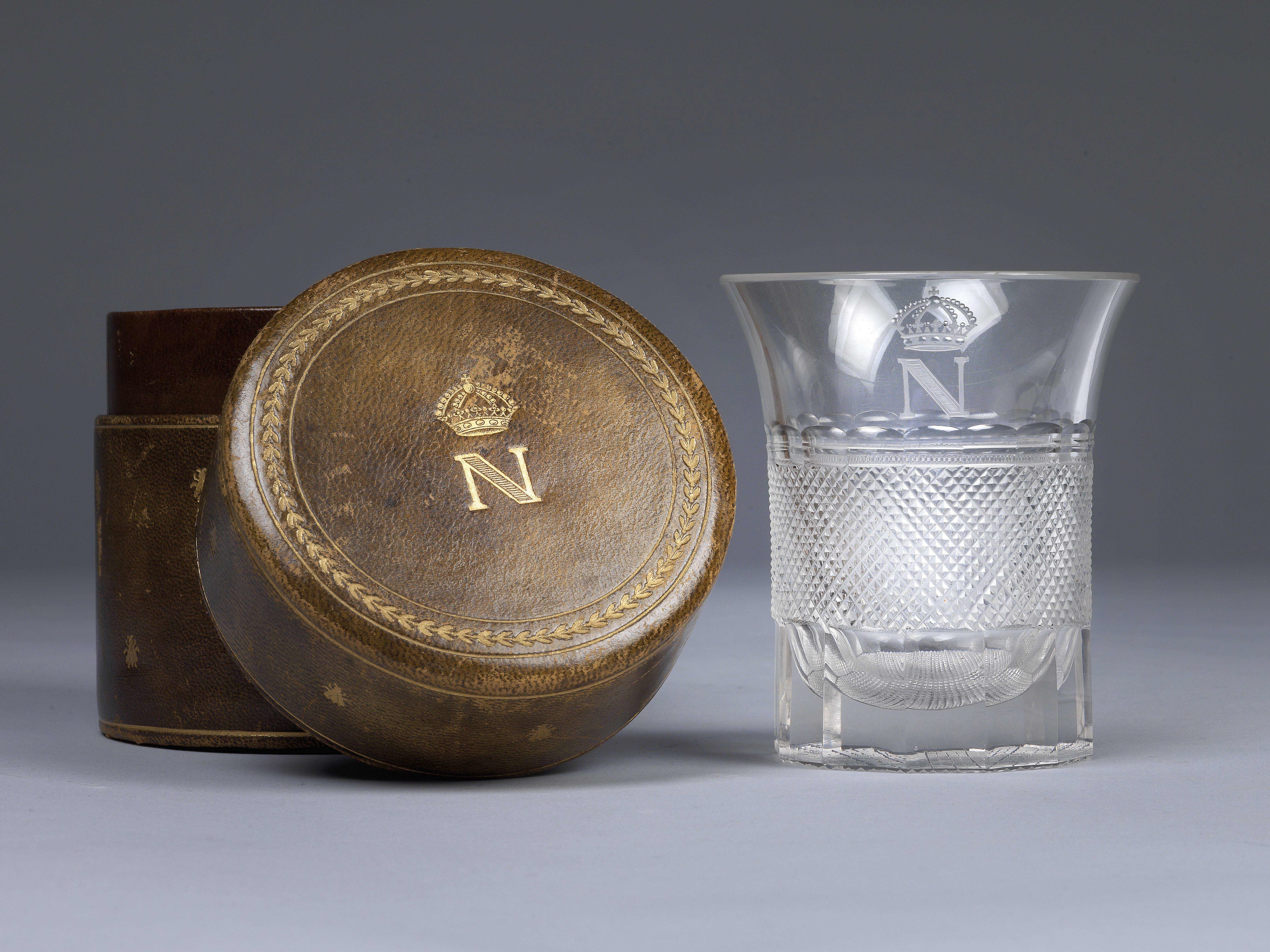 Glass with cut decoration and gilded monogram with crowned N, which belonged to the Emperor Napoleon I. Monogrammed leather case © Dorotheum