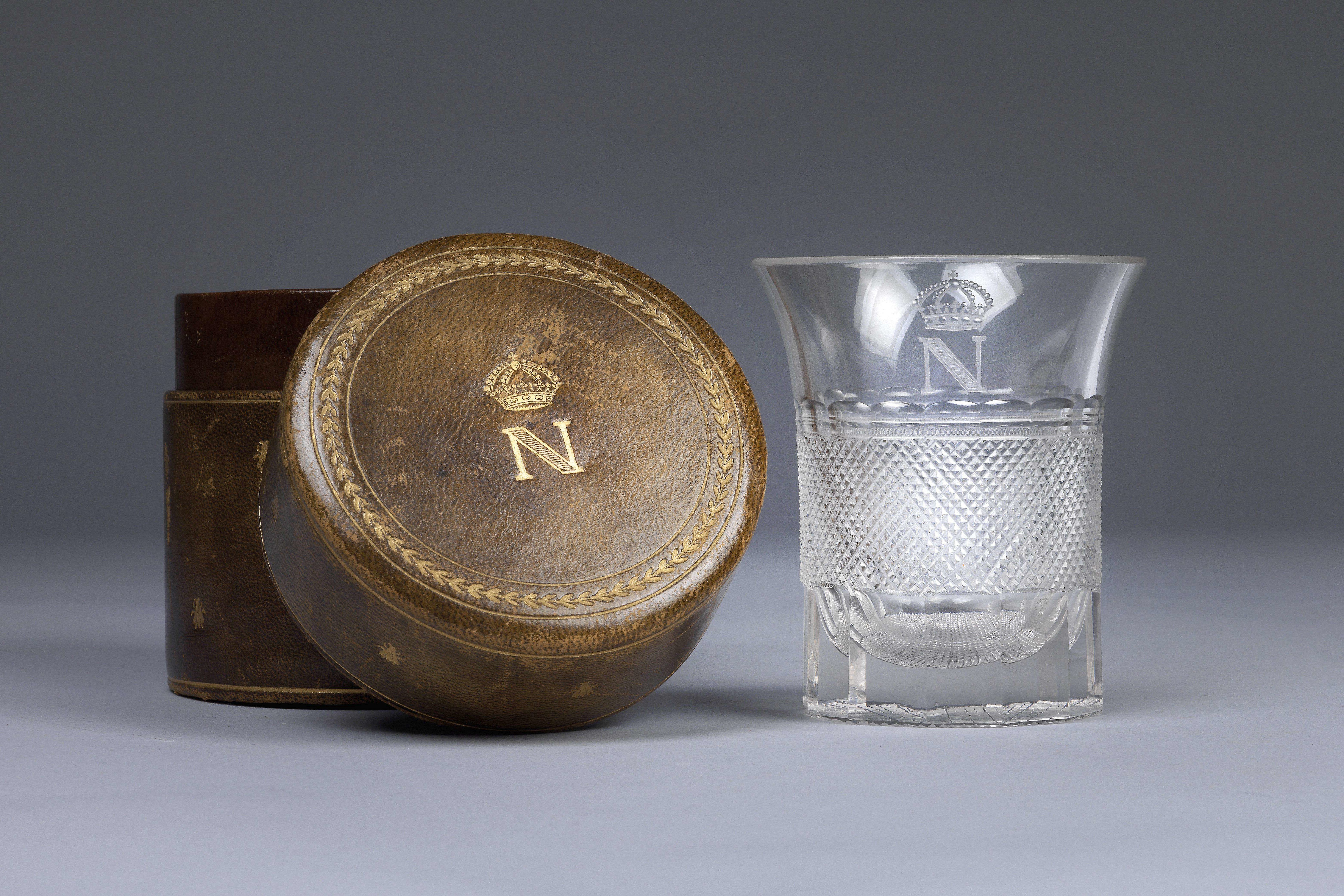 Glass with cut decoration and gilded monogram with crowned N, which belonged to the Emperor Napoleon I. Monogrammed leather case © Dorotheum